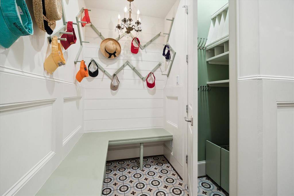 The mudroom features a storage closet with built-ins, perfect combination of practicality and style! It's an essential space for keeping the rest of the home tidy and organized. Built-in shelving, hooks for coats, cubbies for shoes, and a dedicated space for bags or backpacks make it easy to store everything you need as soon as you walk in.