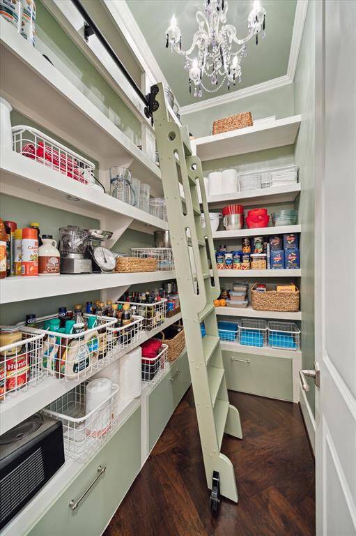 Striking walk-in pantry with a ladder adds so much charm and functionality to a luxurious kitchen! The ladder brings a touch of classic elegance, giving the pantry a timeless feel while also offering easy access to high shelves for extra storage.
