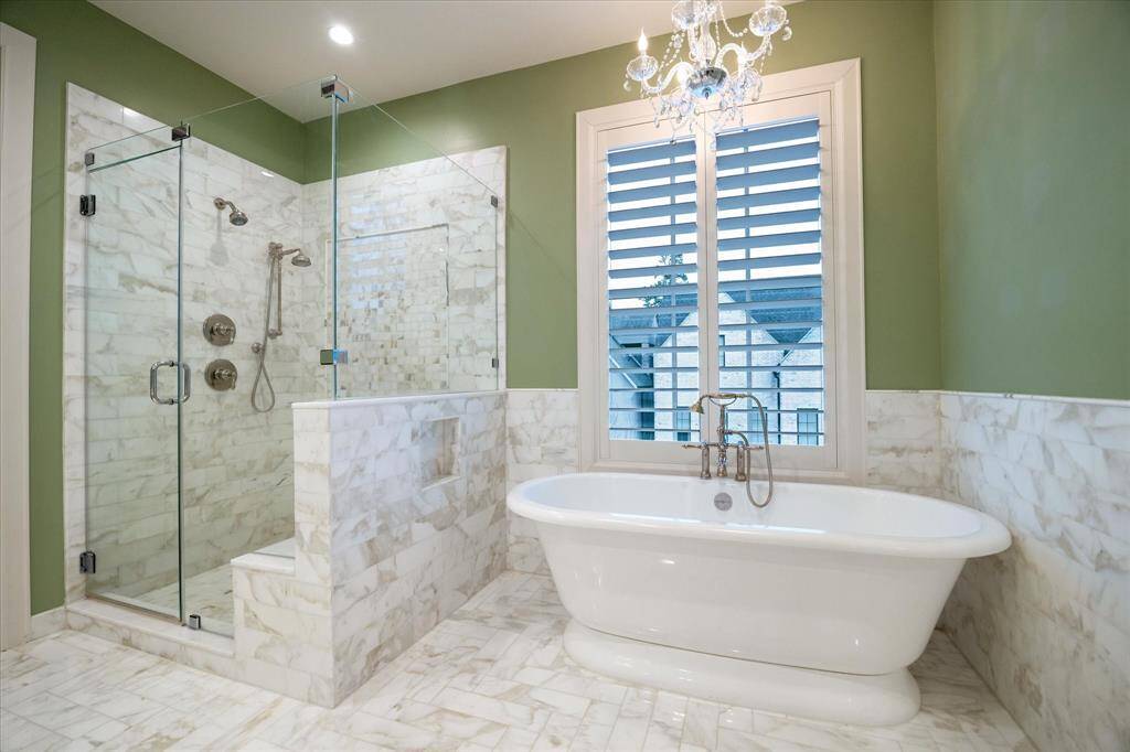 Luxurious standup shower with bench. Soaking tub is the perfect way to unwind and melt away stress.
