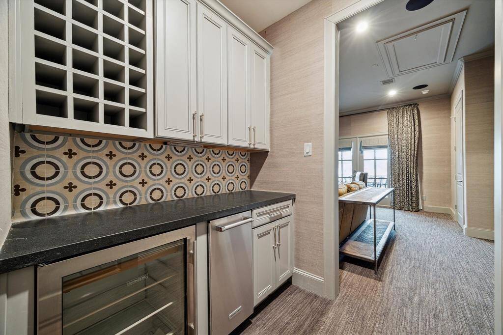 Fourth floor mini bar features a mini fridge, wine cooler. Allows guests to grab drinks, snacks without having to run back to the main kitchen, making it ideal for parties, movie nights, or casual gatherings.