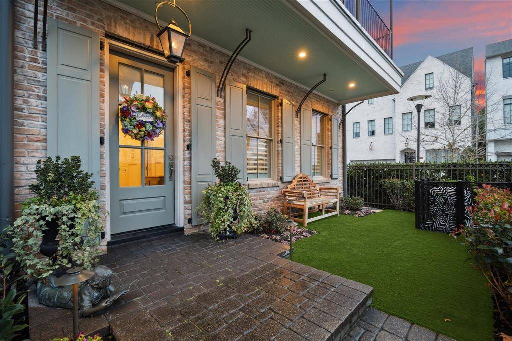Neatly trimmed hedges, lush, and well-placed flower beds with vibrant blooms welcome friends and guests.