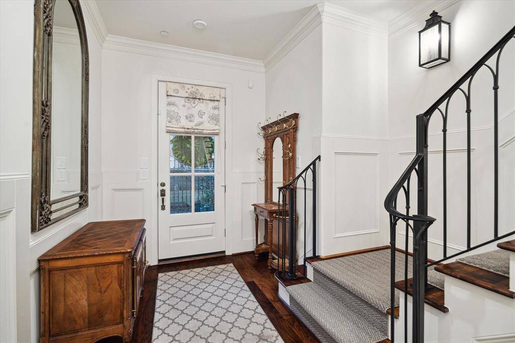 Striking entrance with high ceilings and warm rich flooring.