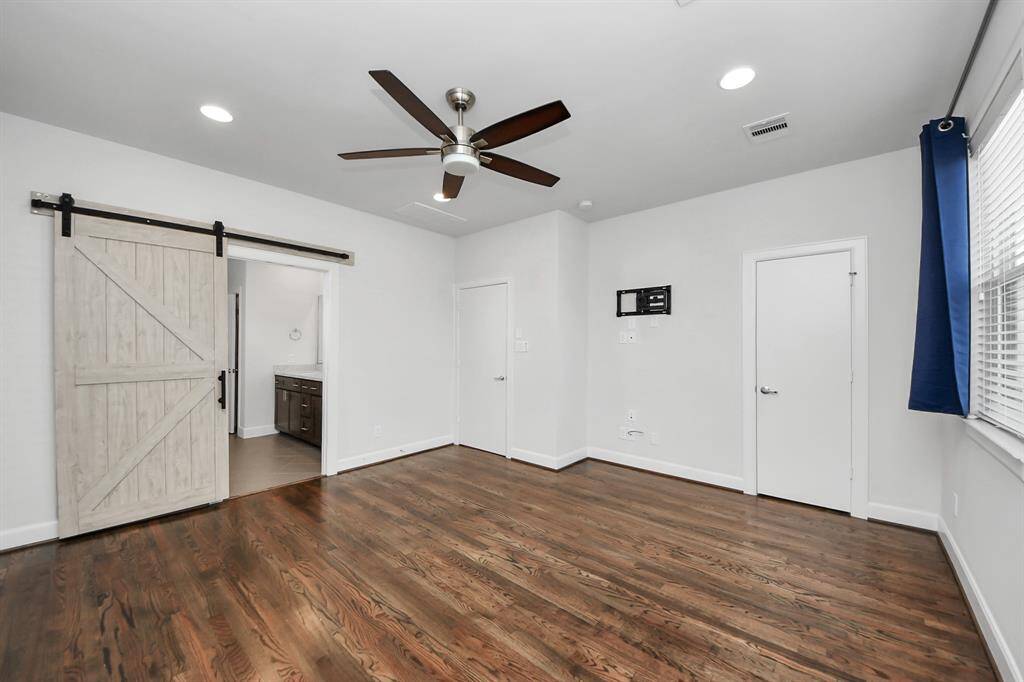 Primary Bedroom with En-Suite Bathroom and Sliding Barn Door