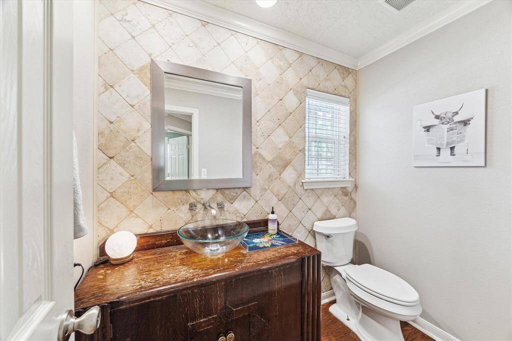This is the half bath - tiled wall along with antique vanity
