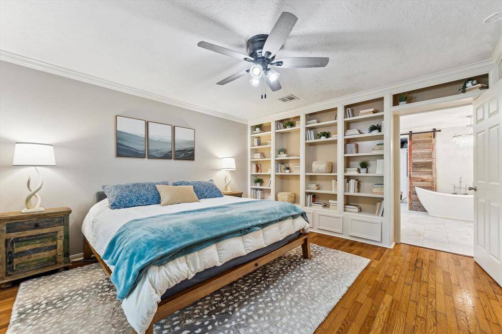 Exquisite built ins along one wall of primary bedroom