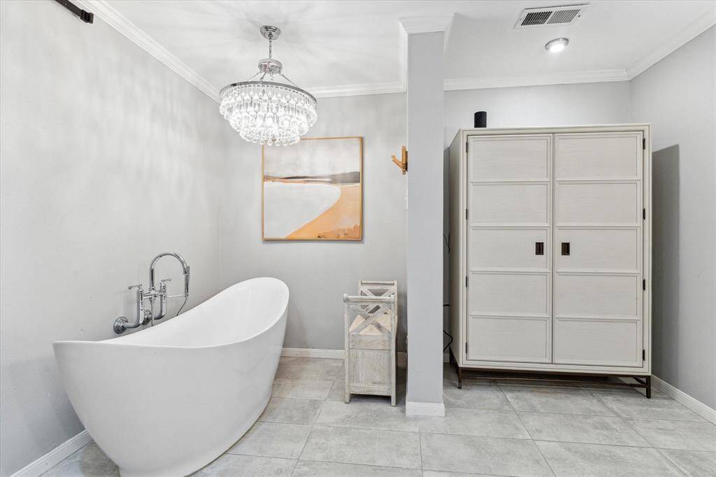 Relax in your own soaking tub, accented by the grand chandelier