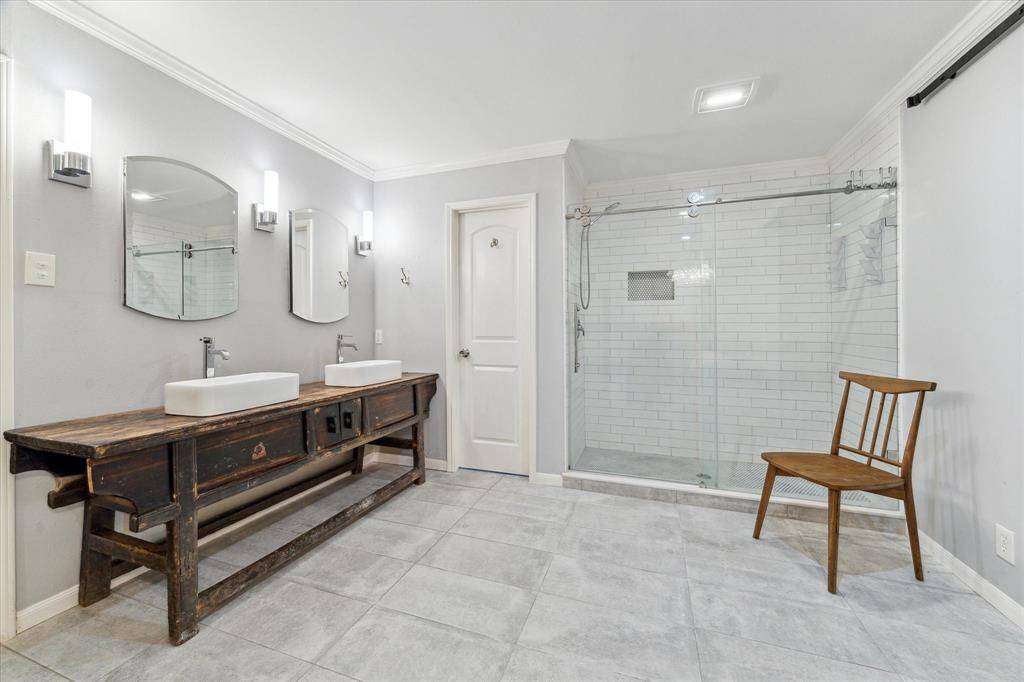 Double sink vanity along with updated mirrors and lighting that give charm to this space