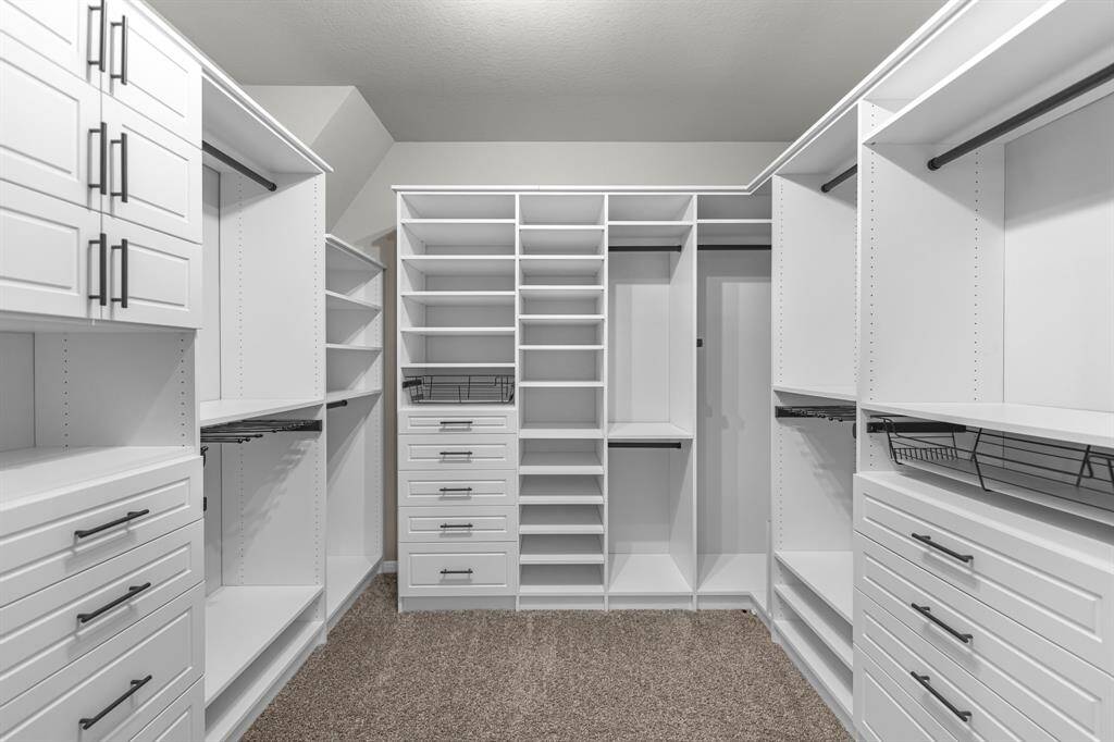 Take a look at this incredible upgrade—your large primary closet features a custom California Closet-inspired design, offering stylish, efficient organization with ample space for all your wardrobe and storage needs.