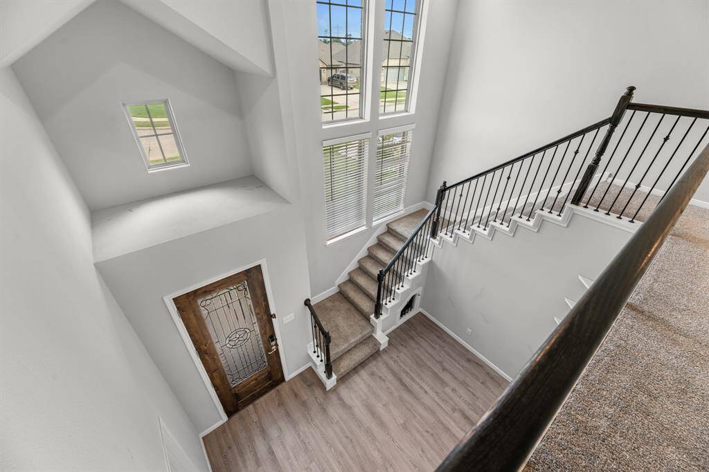 Back at the front of the home, you’ll find a beautifully designed staircase that adds architectural interest without impacting the size or flow of the family room. This area also includes a cozy seating nook—perfect for reading, relaxing, or welcoming guests.