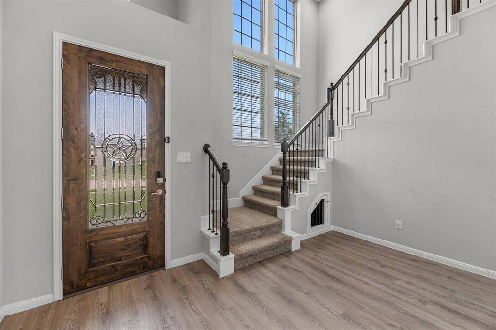 The upgraded front door opens to a spacious foyer that includes an extra seating area, setting the tone for this thoughtfully designed split floor plan home. The staircase is perfectly positioned so it doesn’t intrude on the family room, preserving both space and flow throughout the main living areas.