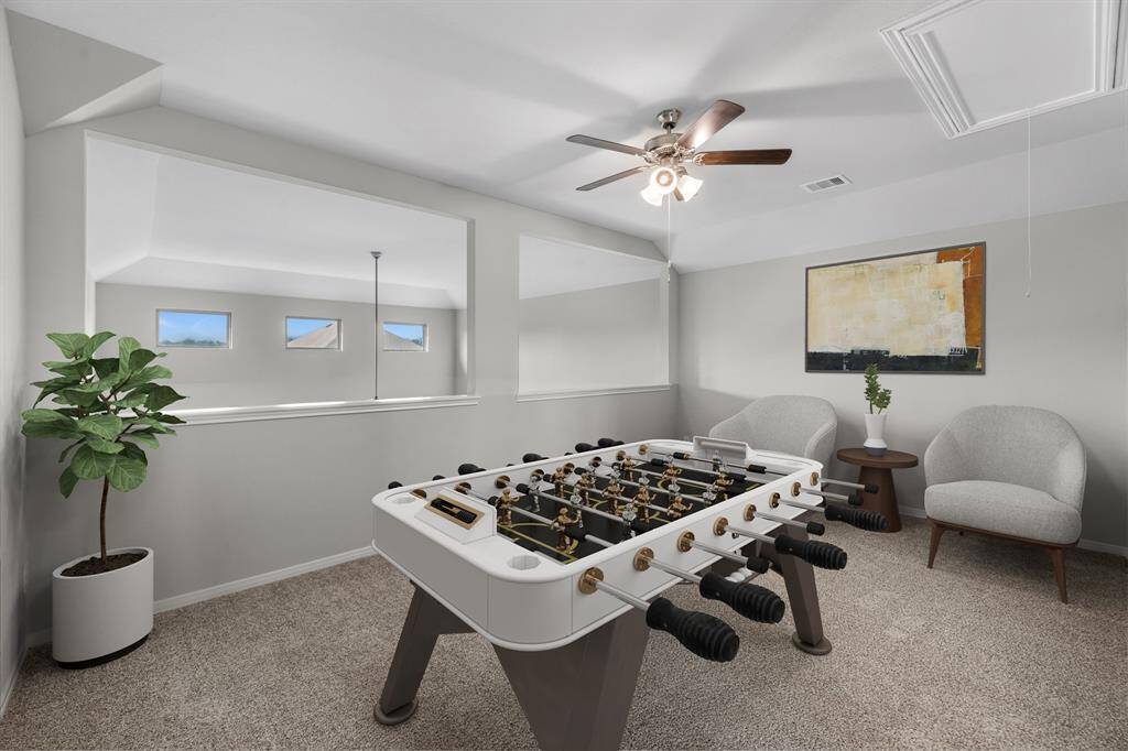 The game room, virtually staged to showcase its versatility, is open to the downstairs living area and spacious enough to accommodate a pool table, exercise equipment, or even an additional media space—perfect for keeping the kids entertained and giving everyone room to spread out.
