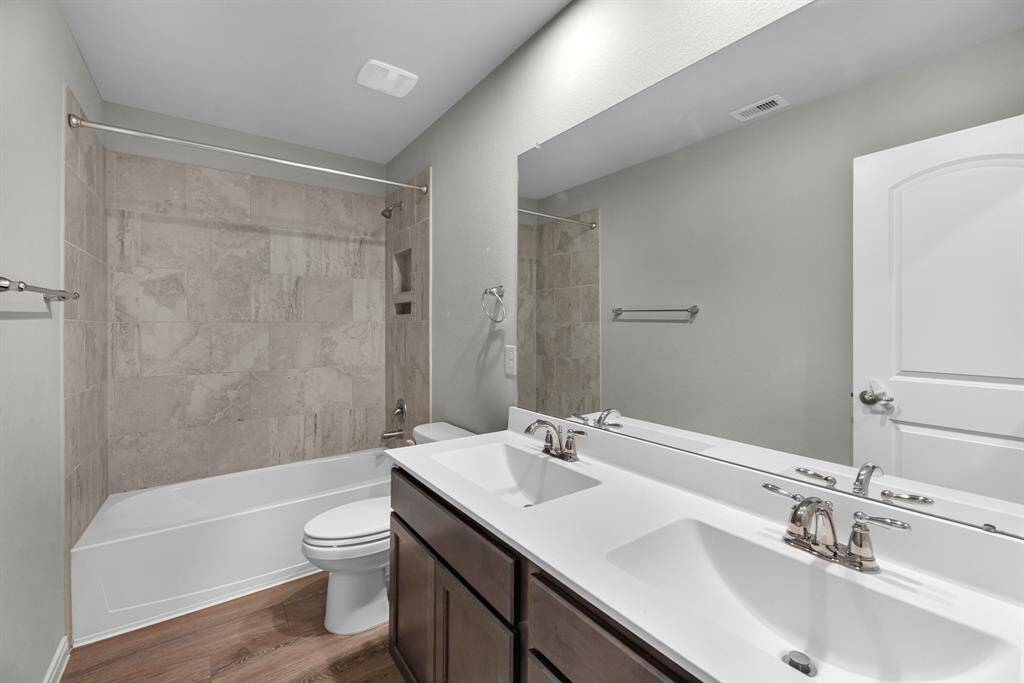 The full secondary bathroom upstairs features double sinks—perfect for busy mornings when the kids need to get ready at the same time, offering both convenience and functionality.