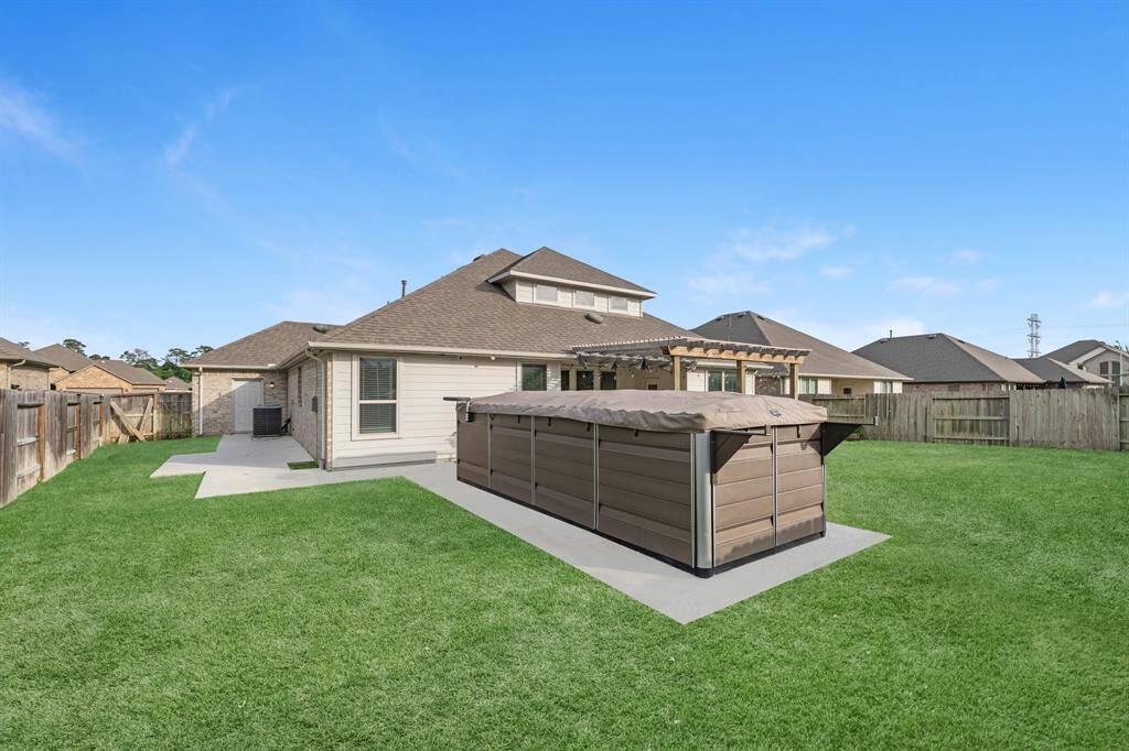 Enjoy convenient access to the backyard through a dedicated garage door from the spacious 3-car garage. The additional concrete area adds extra functionality—perfect for storage, outdoor projects, or easy access to the swim spa and backyard space. Plus, the home is equipped with a full sprinkler system and complete gutter coverage, helping you maintain your landscaping with ease and protect your investment year-round.