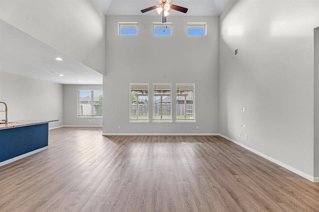 This spacious family room offers plenty of room for all your furniture, making it the perfect place to create a comfortable and stylish gathering space for family and friends.