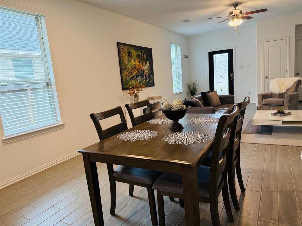 With its open-concept layout and abundant natural light, the dining area enhances the home's welcoming and airy atmosphere.