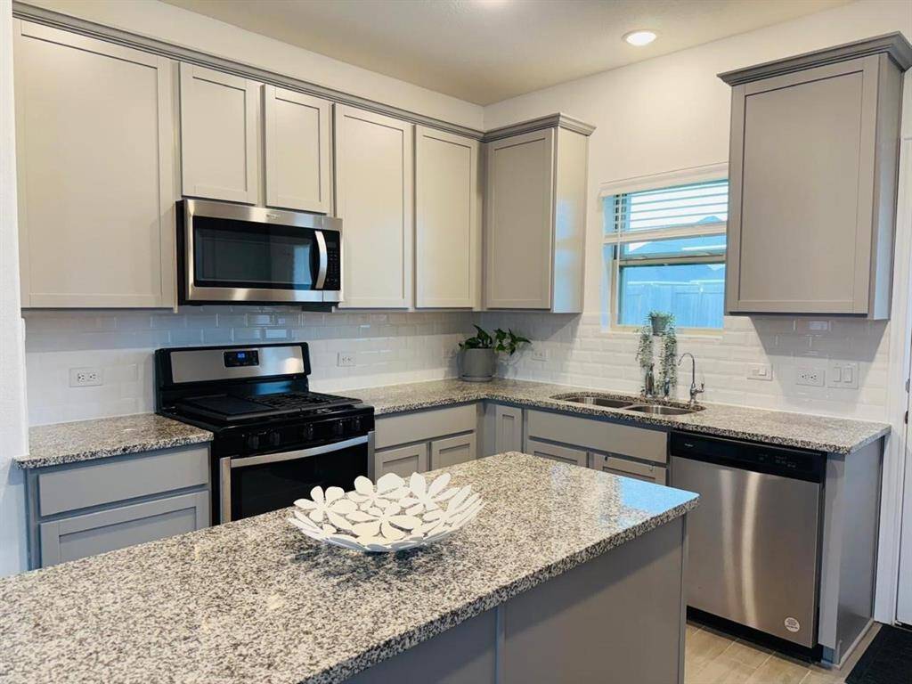 The dining area sits perfectly between the kitchen and living room, creating a natural flow for both casual meals and entertaining. Its open design keeps the space feeling connected, bright, and inviting.