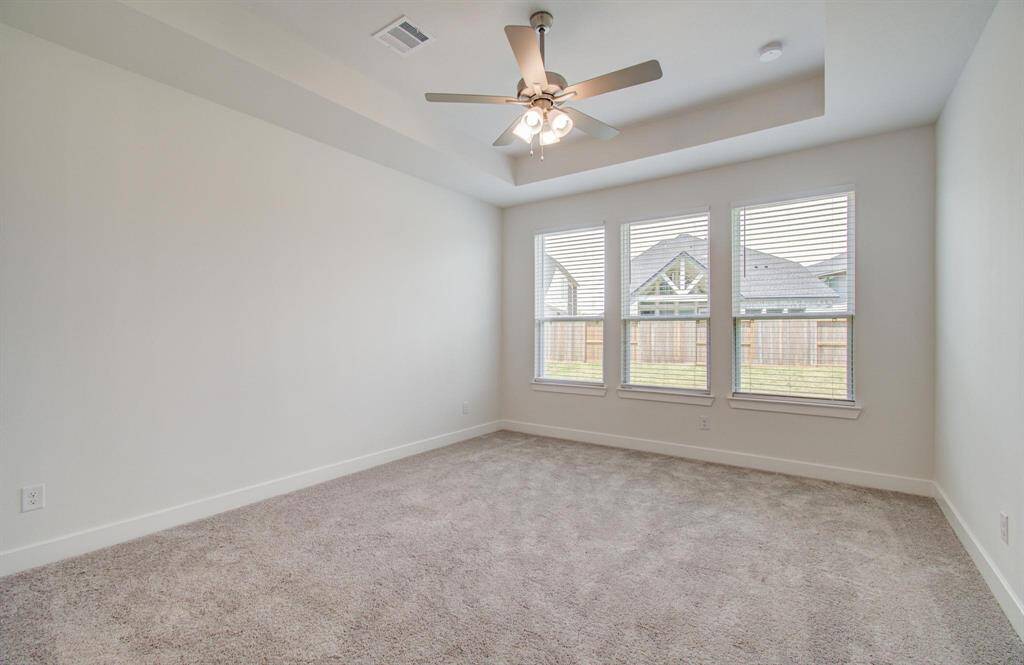 Primary bedroom downstairs with tray ceilings