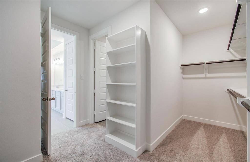 Primary closet with built in shelves
