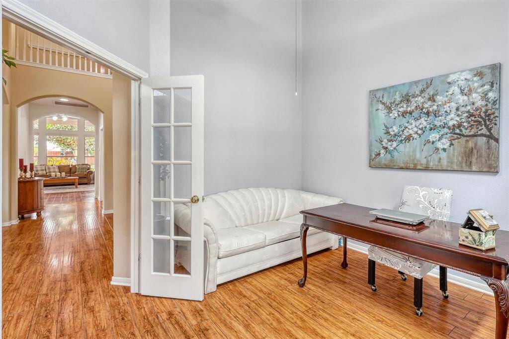 Tucked behind French glass doors, the spacious home office offers a quiet retreat for work or study.