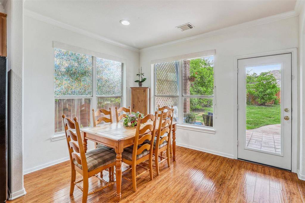 Bathed in natural light, this cheerful breakfast area offers a comfortable and welcoming space for casual dining, while maintaining an open connection to the kitchen, family room, and backyard paradise, for effortless everyday living.