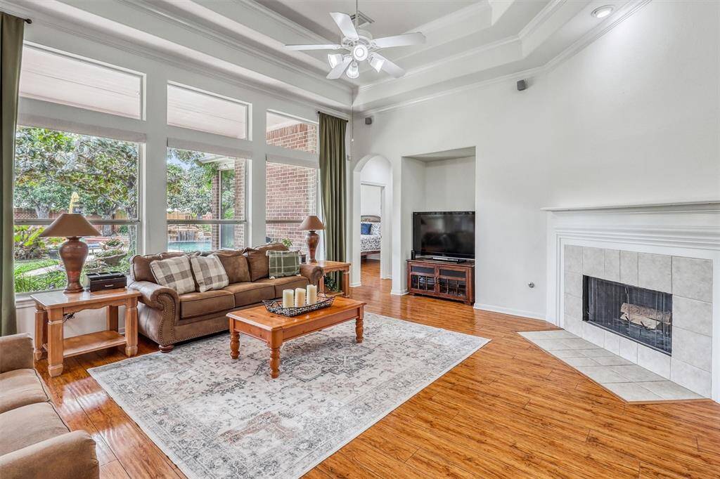 Expansive windows line the family room, allowing natural light to pour in & illuminate every corner of the space. These generously sized windows are crowned with elegant transoms that not only enhance the architectural appeal but also maximize the light flow, creating a bright & uplifting ambiance throughout the day.