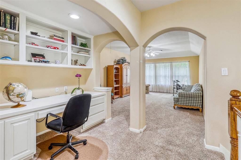 A convenient built-in desk just off the game room provides a dedicated space ideal for work, study, or creative hobbies.
