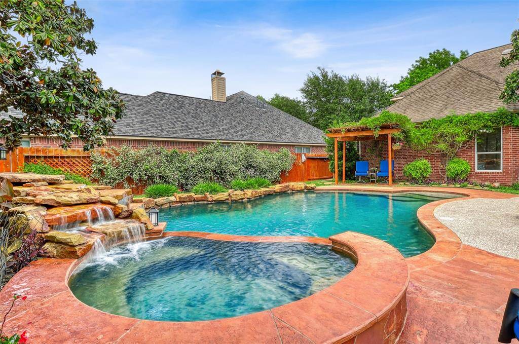 The stunning rock waterfall cascades gently into the pool, creating a soothing atmosphere and enhancing the sense of relaxation throughout the space.