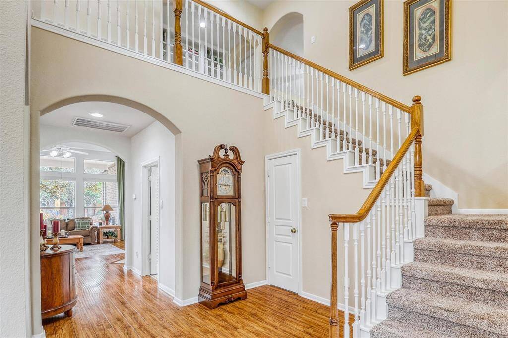 As you step inside, you're greeted by a soaring foyer ceiling, gleaming wood floors, an abundance of natural light, and a soothing palette of neutral tones that set a serene and elegant tone throughout.