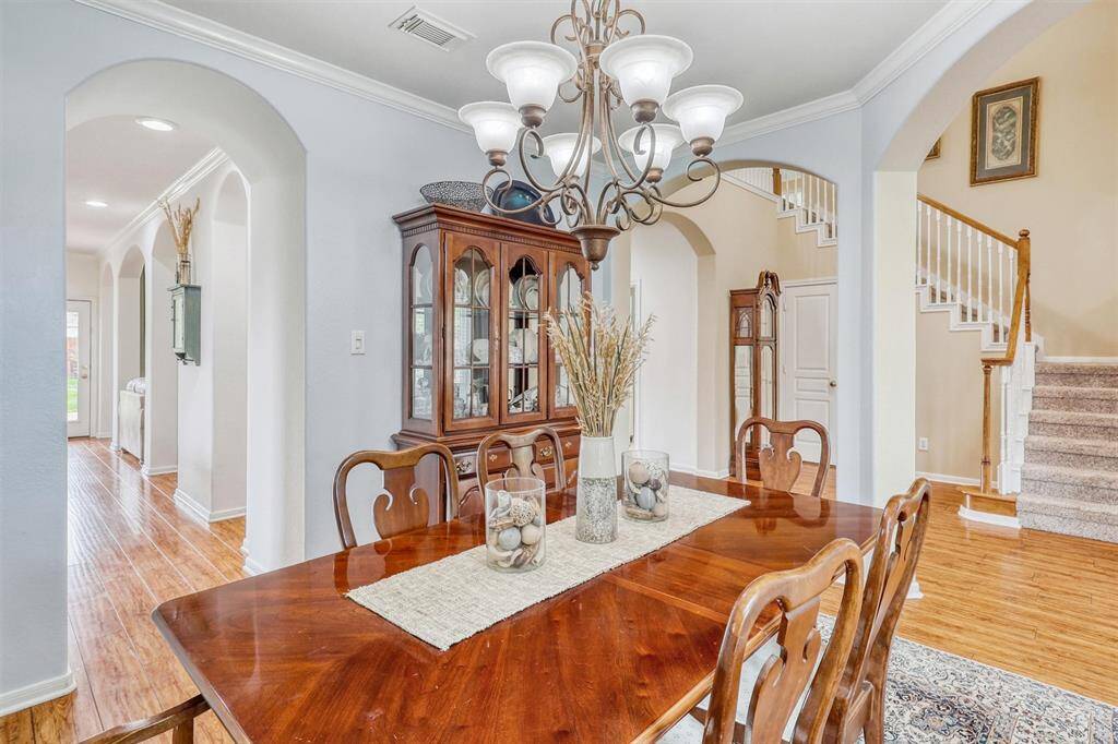 An elegant archway frames the entrance to the room, adding architectural charm and sophistication. For added convenience, the space offers direct access to the kitchen—perfect for seamless entertaining and effortless serving.