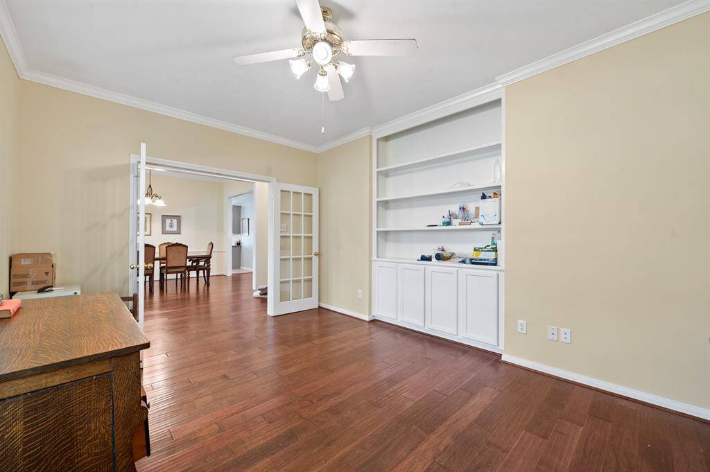 Office space with built in shelving, lots of storage and glass french doors