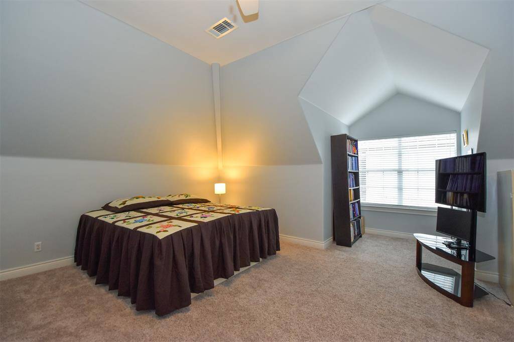 3rd Floor bedroom # 4 with vaulted ceilings, neutral wall paint. Can be used as a flex / hobby room or an office.