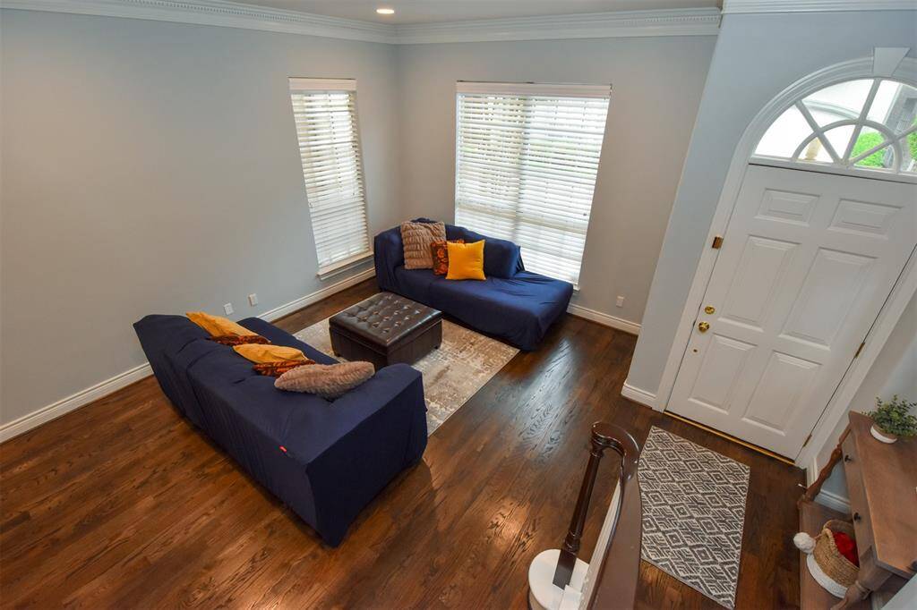The entryway features a white door with an arched window, adding character to the space.