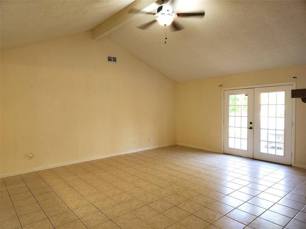 Looking at the living room from the hall by primary bedroom