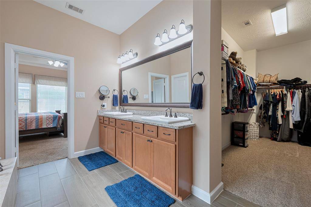 The primary bath connects to a well-organized walk-in closet.