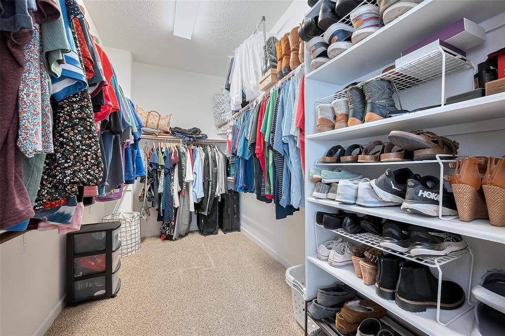 A spacious walk-in closet with ample shelving and hanging space.