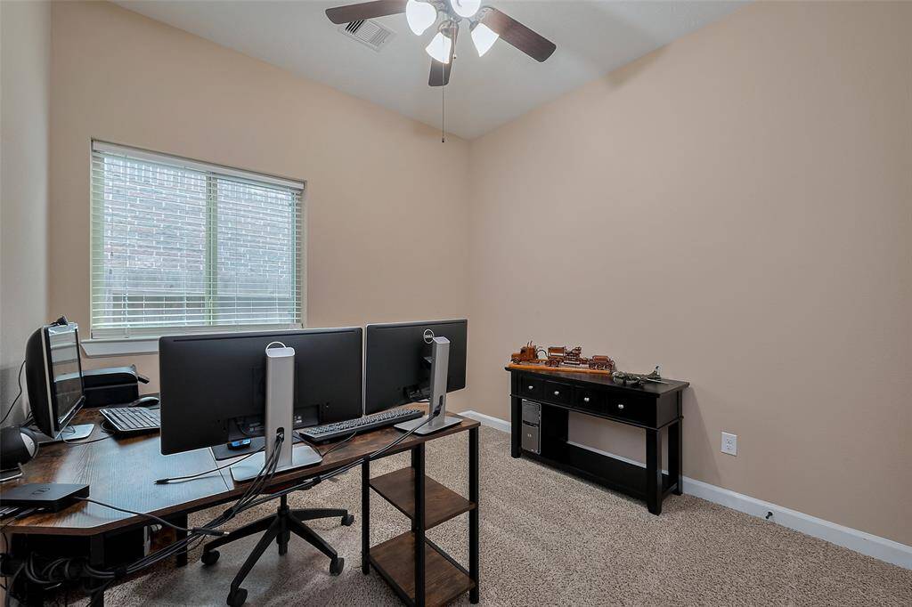Bedroom 4: This bedroom is set up as a home office.