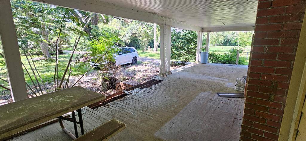 Massive front porch goes the whole width of the home.  There is some wood rot just near the front steps.  Other than that, the decking is solid to walk on.