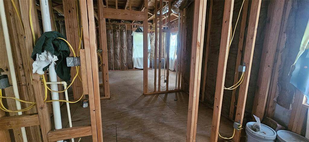 View from the backdoor entry into full bathroom and in far back is slated for a bedroom, but could be used as an office.
