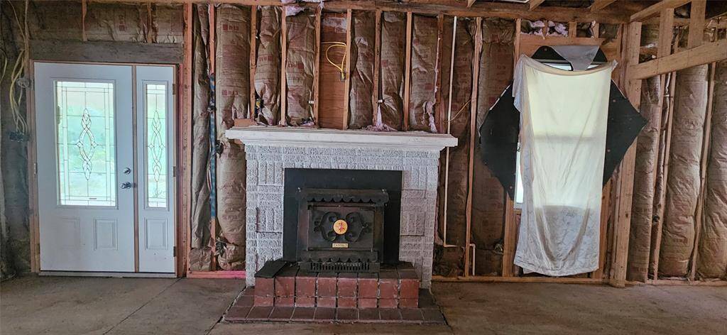 Living room with original wood burning fireplace.