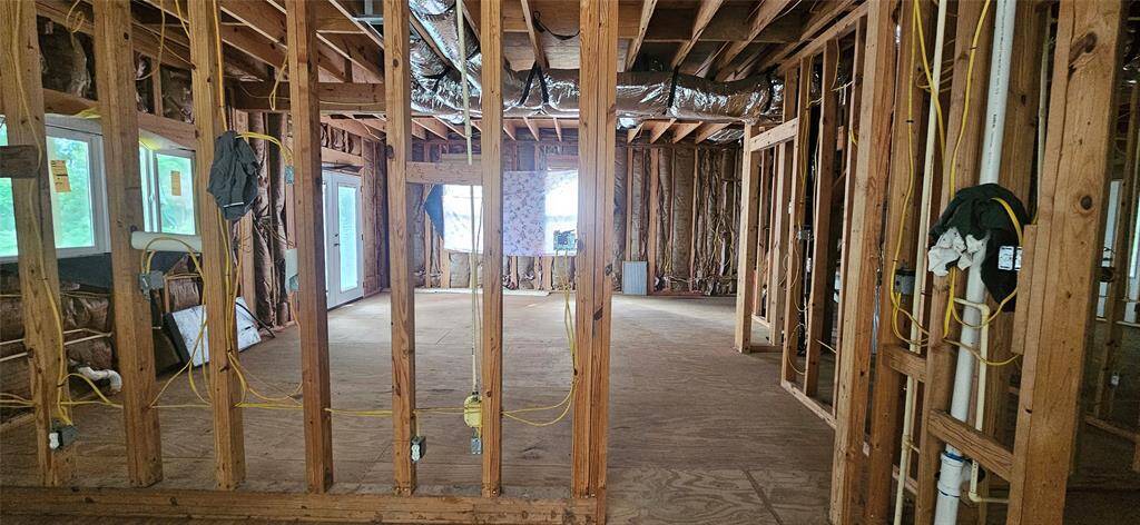 View of the kitchen / dining room area from the back entryway. Windows on the left face the water.