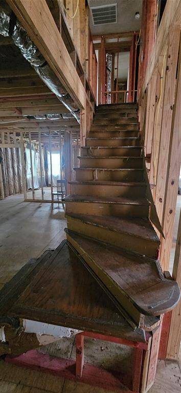 In the far back left of the photo is the downstairs bedroom on the other side of the living room.