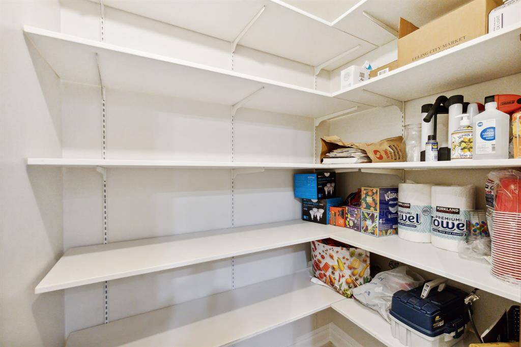 Walk-in pantry with plenty of storage.