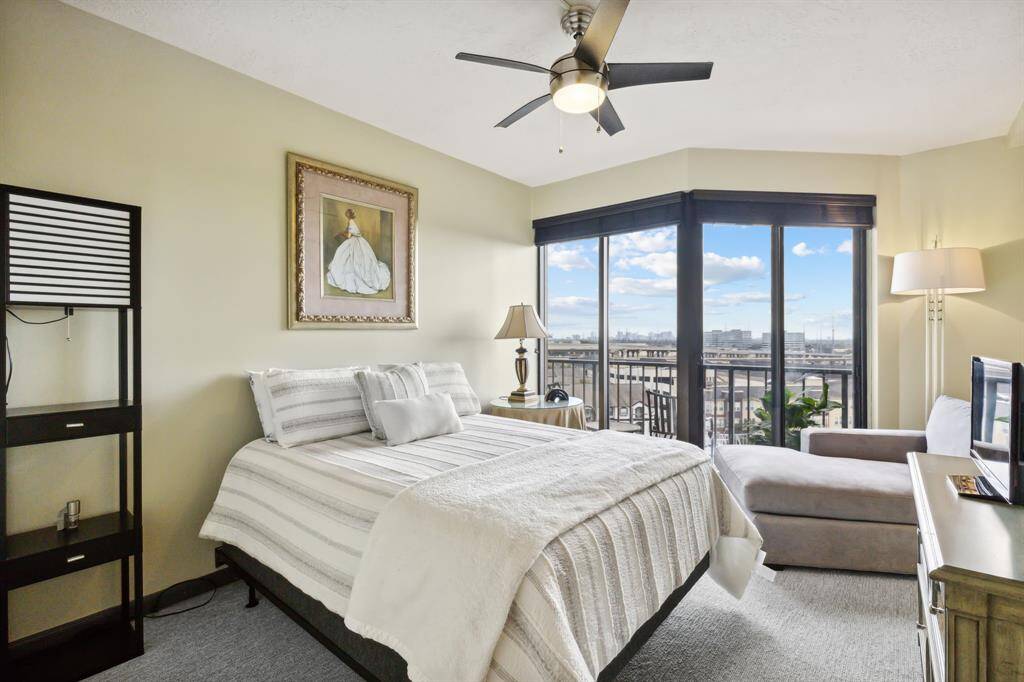 Bright and airy bedroom with a large window that offers an expansive view, bringing in plenty of natural light.