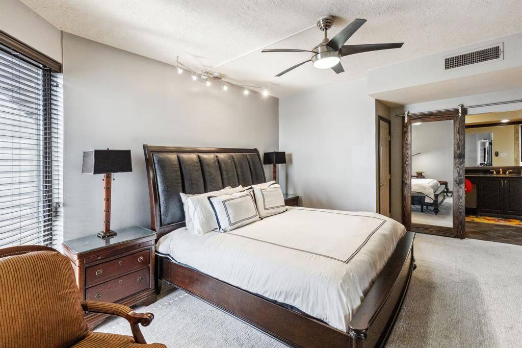 Primary bedroom is oversized and well lit with a nice seating area.
