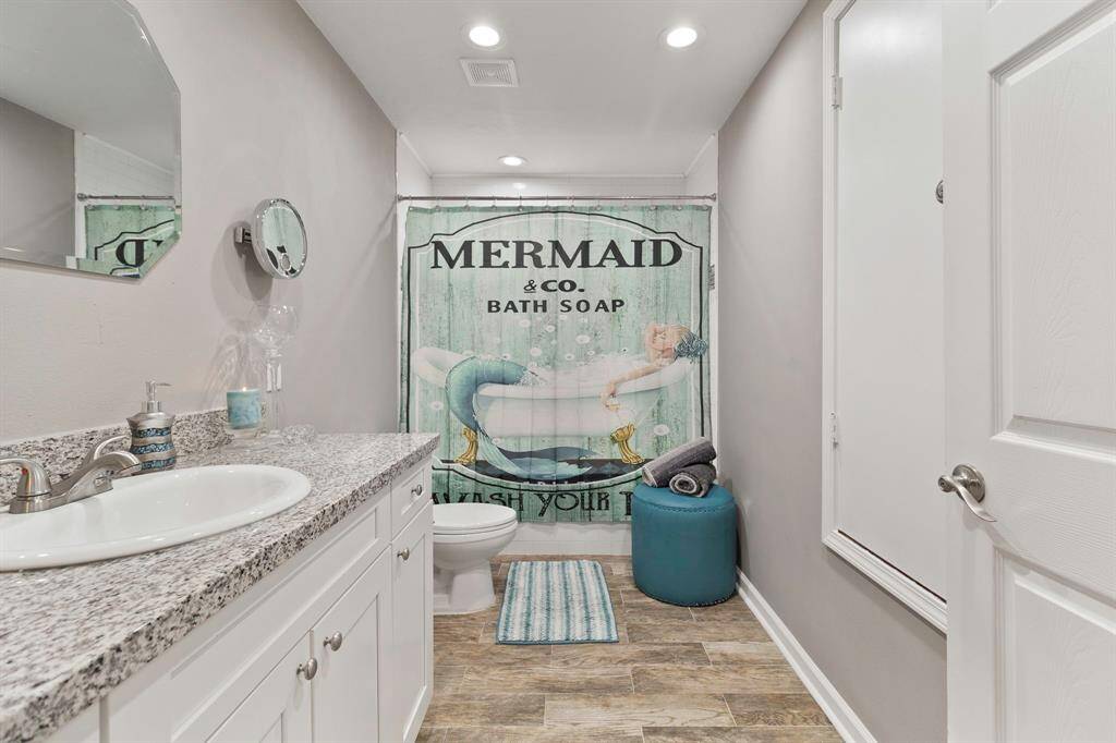 Second full bathroom with soaking tub/ shower combo and candle ledge.