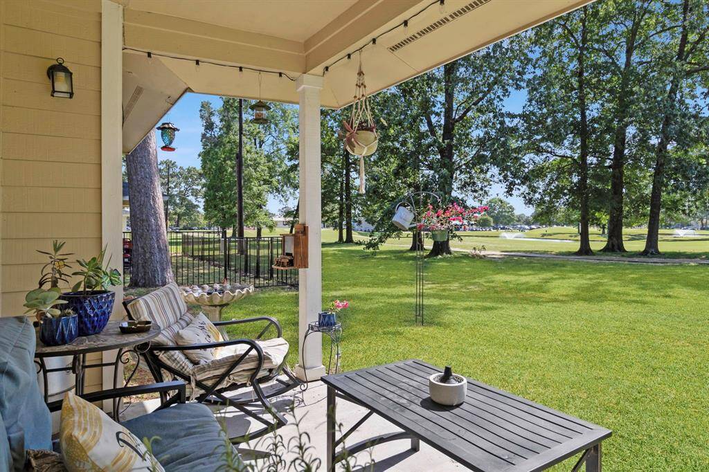 Spacious back porch with views of ponds, golfing, wildlife and a perfect spot for coffee and BBQ! At night enjoy sunsets and accent lighting.