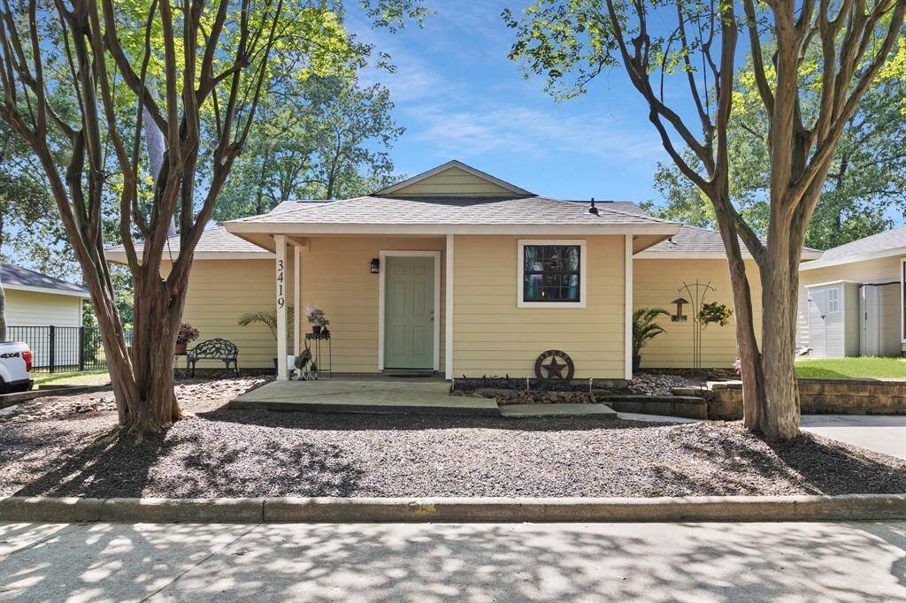 Front entry way, Zen rock garden and assigned two car parking spots to the right of the house. Enjoy your canopy of Crepe Myrtles as you enter your boutique community.