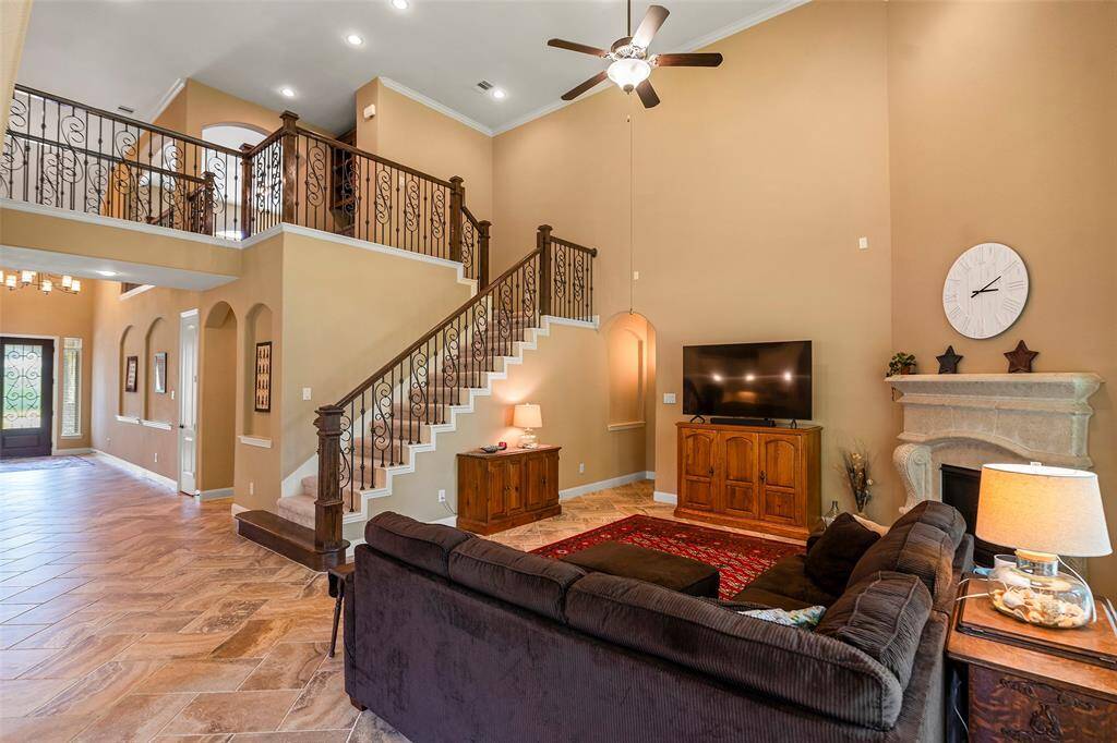 The wrought iron staircase leads upstairs to the built-in study area, game room, 3 bedrooms and 2 full bathrooms.