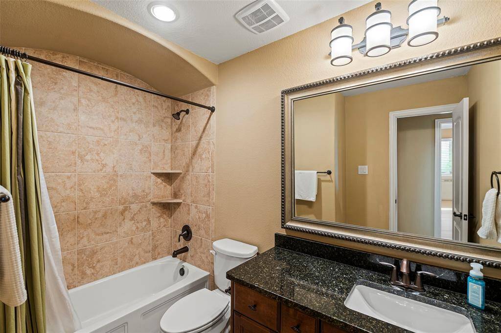 Upstairs bathroom with granite counter and shower /tub combo shared by bedrooms 2 and 3.