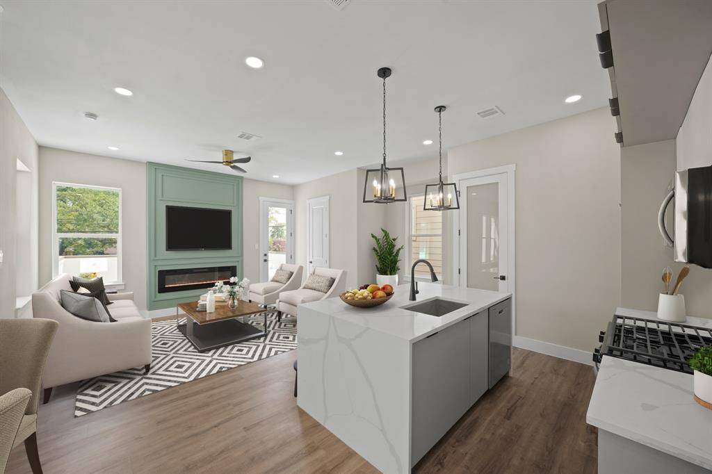 Virtually Staged: This stunning living room features new recessed lighting and vinyl plank floors, and a gorgeous electric fireplace that puts out heat.